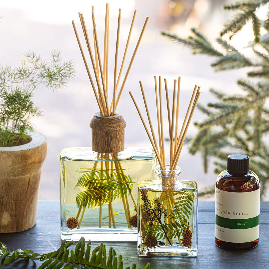 Large and Small Rosy Rings Forest Scented Reed Diffuser displayed next to Diffuser Refill Bottle