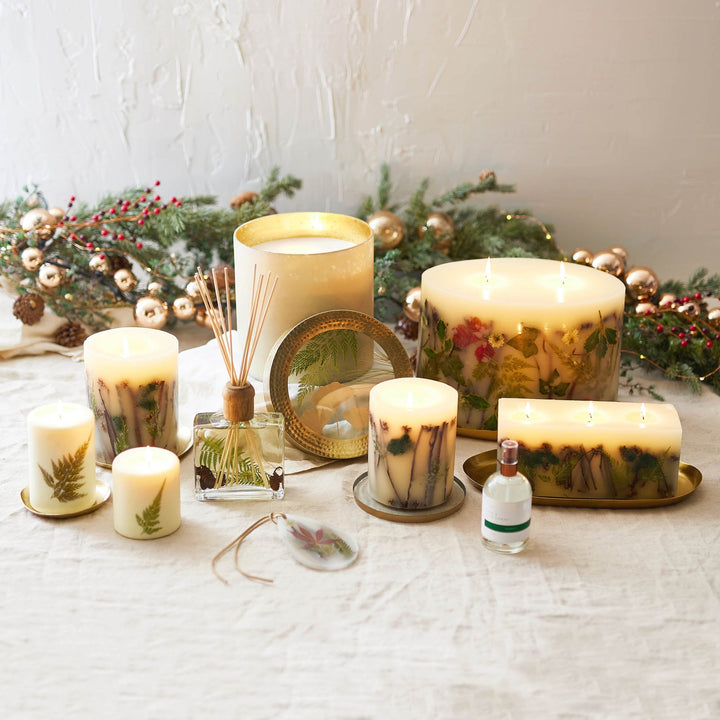 Rosy Rings Forest Scented Reed Diffuser displayed next to  Forest Collection Candles in various sizes